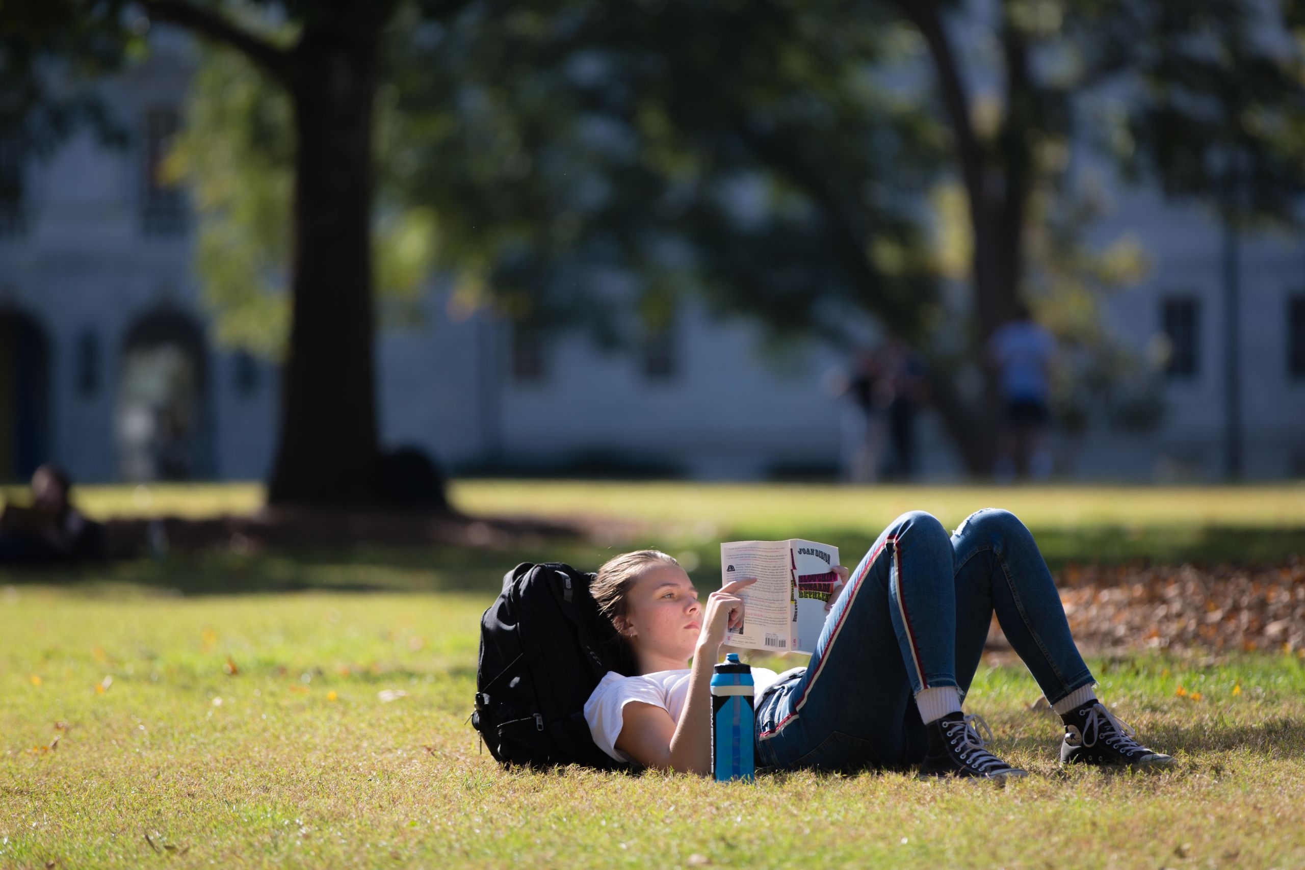Girl reading in Emory quad
