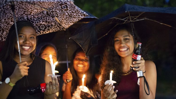 Four Emory students participate in the 2018 Candlelight Crossover as part of the 2018 Emory Commencement traditions