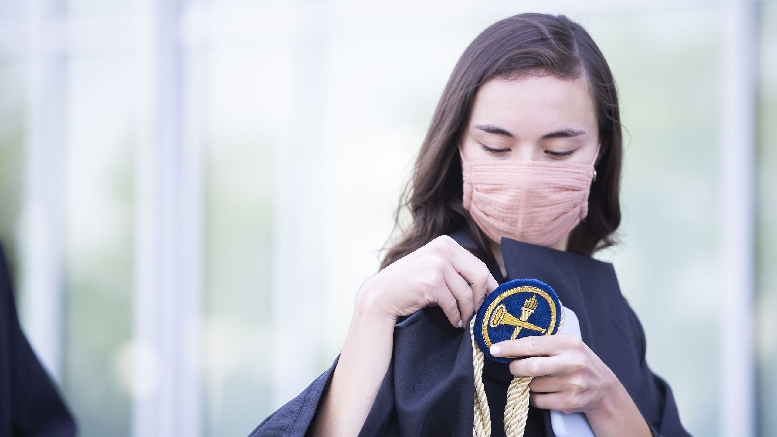 Graduate fixing robe outside