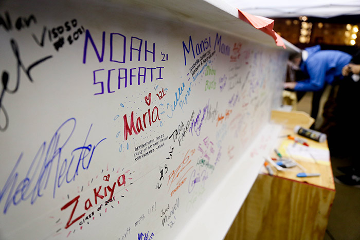 Several names in many colors adorn a large steel beam.